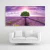Schallschutzbild Dreamy mit Lavendelfeld, lila farbenen Himmel und Baum. Weißer Rahmen im Querformat 2 zu 1 über weißem Sofa.